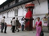 Kathmandu Durbar Square 06 02 Hanuman Statue The Hanuman (1672) statue stands at the entrance to the Hanuman Dhoka palace in Kathmandu Durbar Square. The Hindu god Hanuman is depicted as a monkey, and sits on a tall stone pedestal, cloaked in red and sheltered by an umbrella. Standards bearing the double-triangle flag of Nepal flank the statue. I watched the devout Hindus circle the statue, touching their foreheads on the Hanuman pedestal.